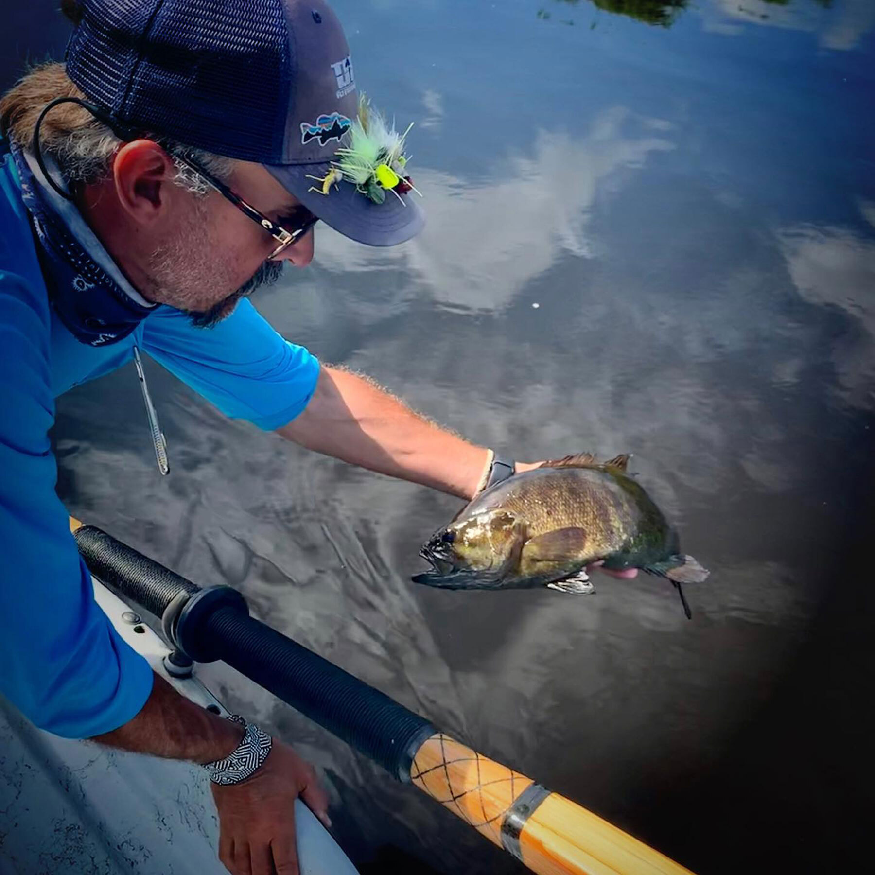Tim Landwehr releasing a Smallmouth Bass